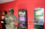 Funkcjonariusz KAS wewnątrz lokalu z nielegalnymi automatami do gier hazardowych